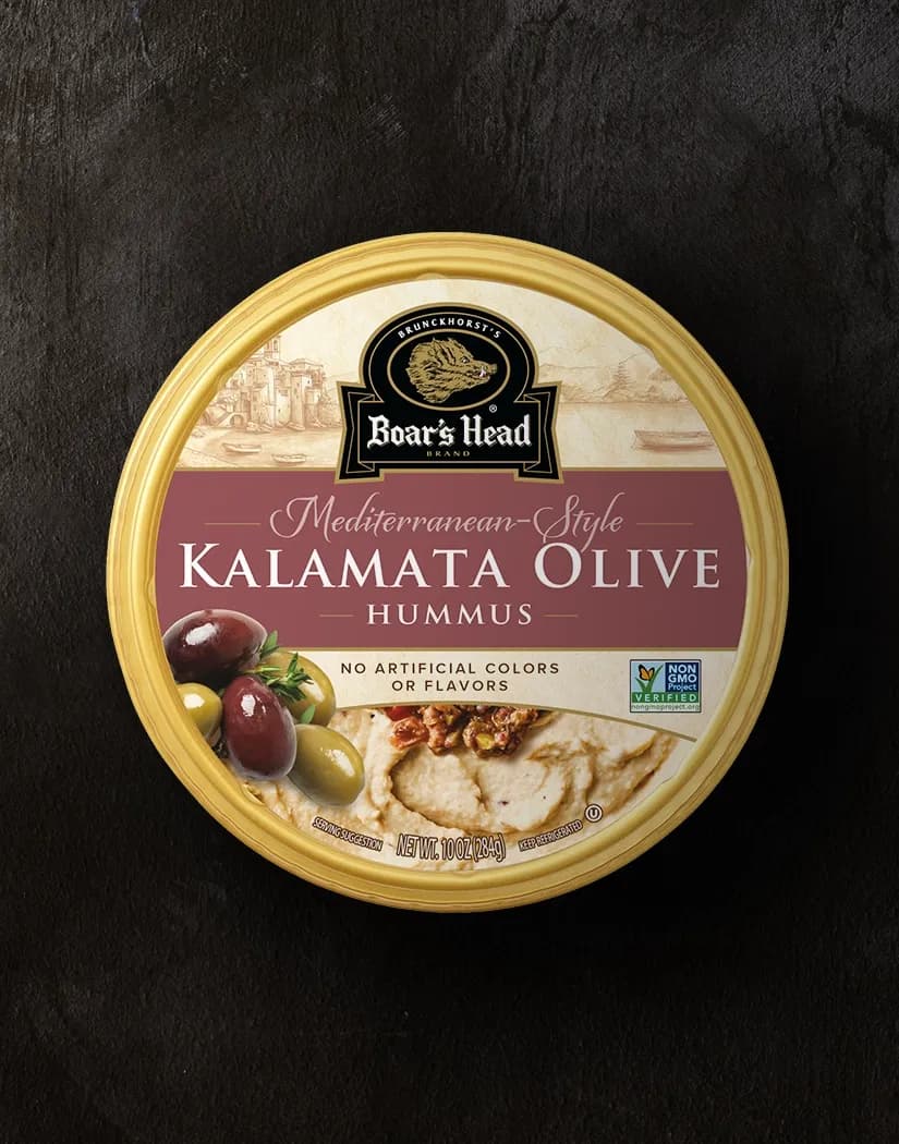 An aerial view of the Boar's Head® Kalamata Olive Hummus that sits on a graphite colored background.