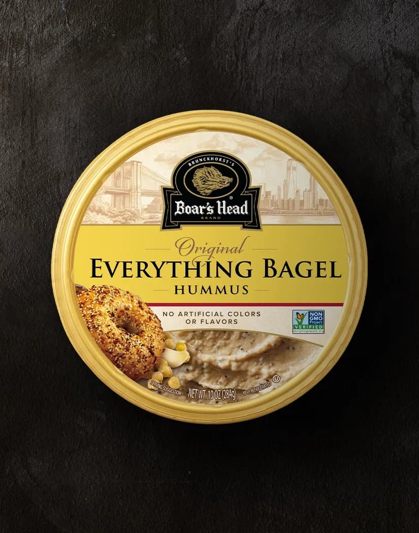 An aerial view of the Boar's Head® Everything Bagel Hummus that sits on a graphite colored background.