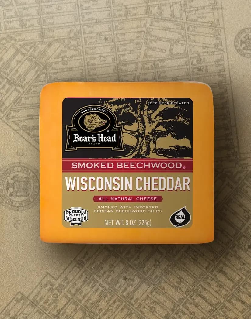The Boar's Head® Smoked Beechwood® Wisconsin Cheddar Cheese sits on a tan illustrated image of New York City.