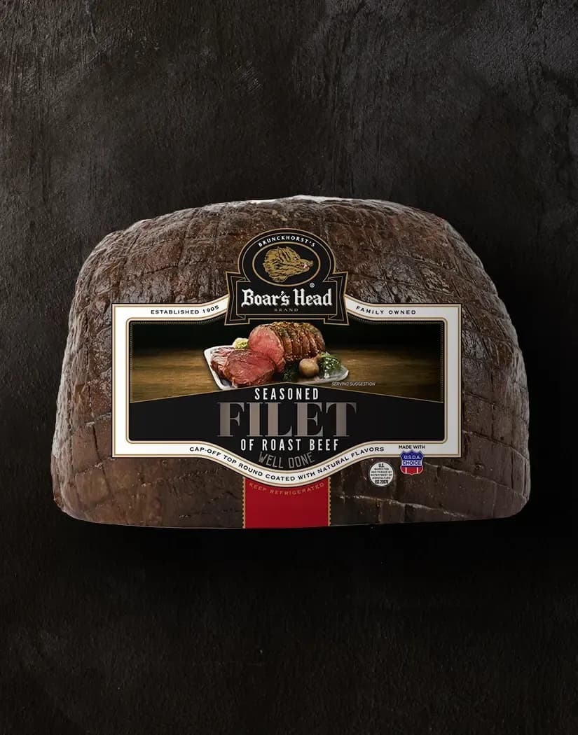 The Boar's Head® Seasoned Filet of Roast Beef - Well Done sits on a charcoal-colored slate background.